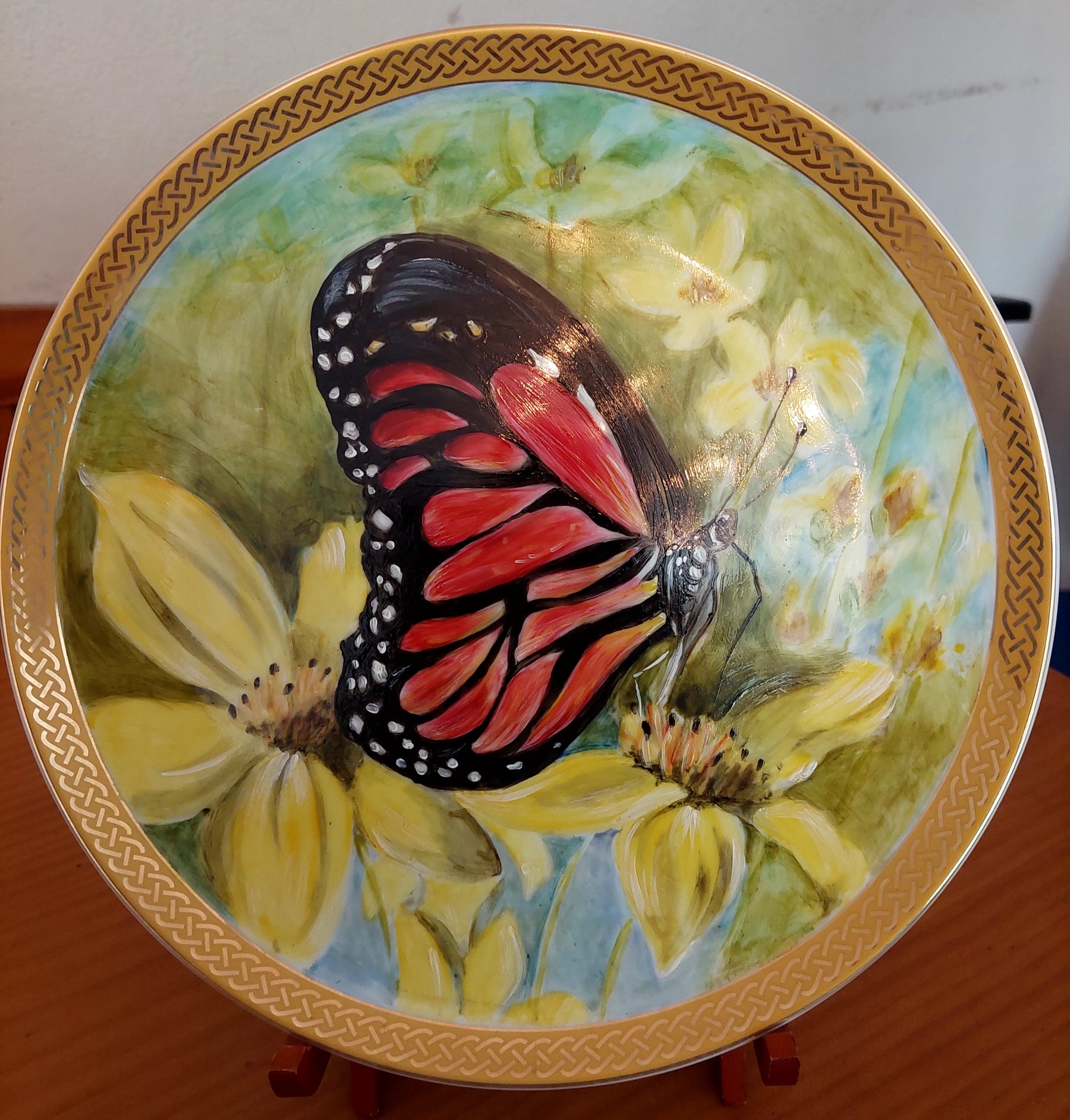 gold banded plate with butterfly and wildflowers
